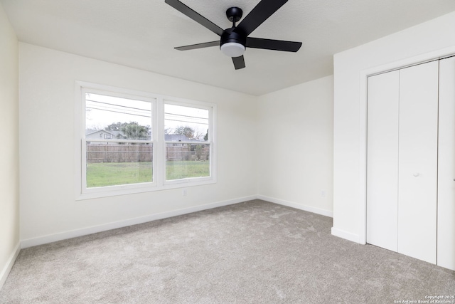 unfurnished bedroom with a closet, ceiling fan, and light colored carpet