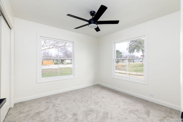 interior space featuring ceiling fan and light colored carpet