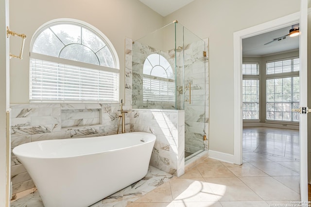 bathroom featuring tile walls and shower with separate bathtub