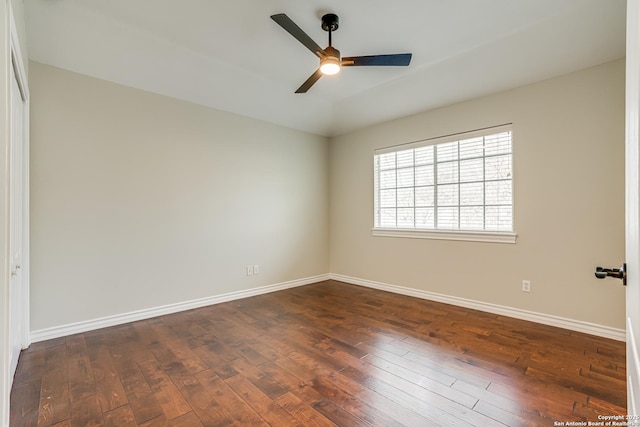 empty room featuring dark wood-type flooring and ceiling fan