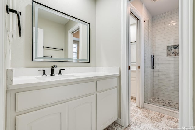 bathroom with tile patterned flooring, an enclosed shower, and vanity