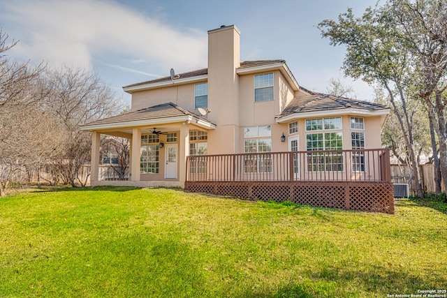 rear view of house featuring a yard, a wooden deck, central AC, and ceiling fan