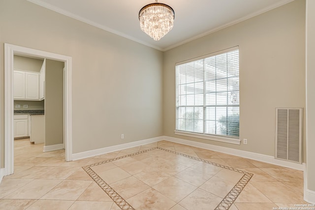 tiled empty room with ornamental molding and an inviting chandelier