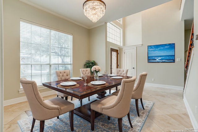 tiled dining space with a notable chandelier and ornamental molding