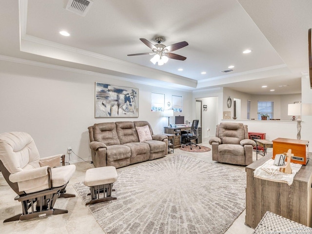 living area featuring ornamental molding, a raised ceiling, and visible vents