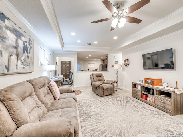 living area featuring baseboards, visible vents, a tray ceiling, crown molding, and recessed lighting