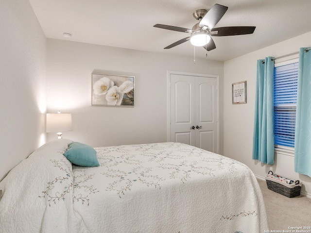 bedroom with carpet floors, a closet, and a ceiling fan