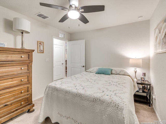 bedroom with baseboards, visible vents, and light colored carpet