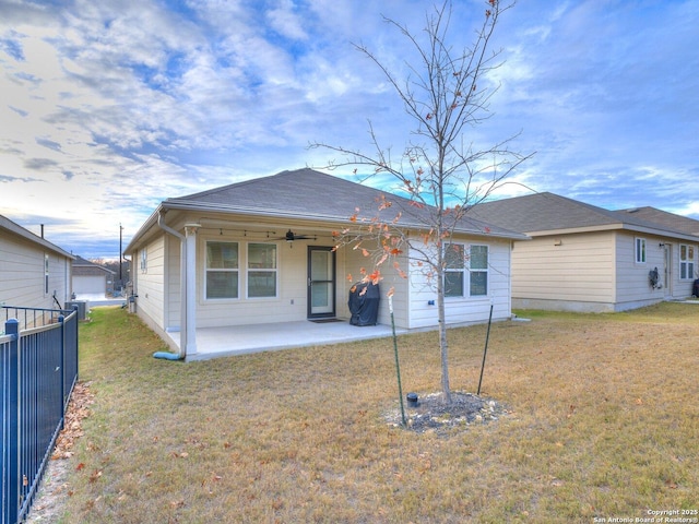 rear view of house featuring a lawn, a ceiling fan, a patio area, fence, and cooling unit