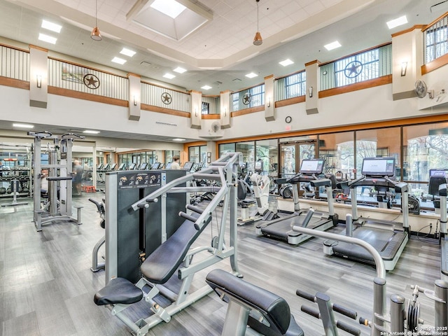 gym with carpet floors and a towering ceiling