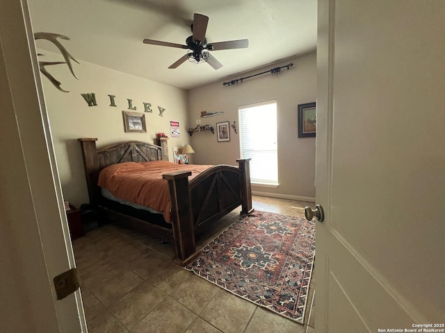 tiled bedroom featuring ceiling fan