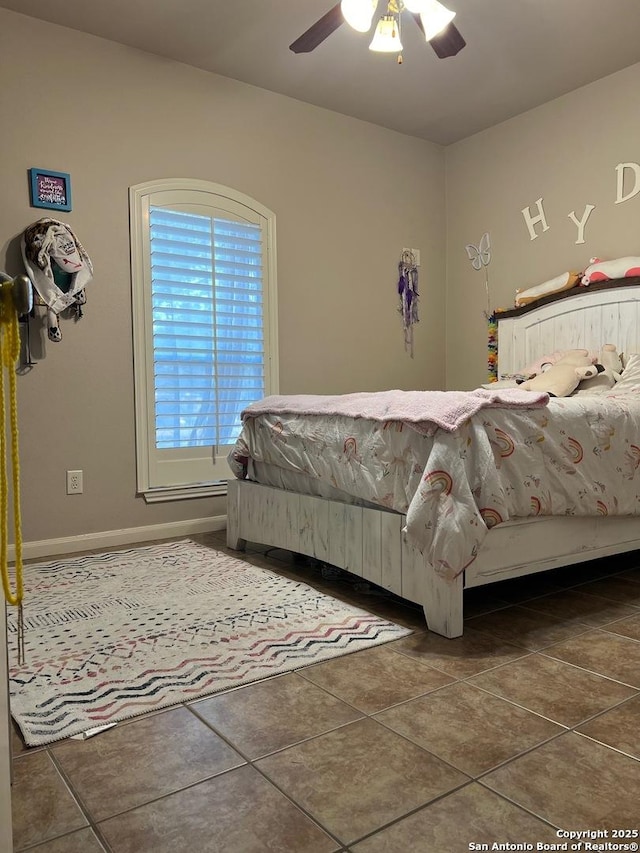 tiled bedroom featuring ceiling fan