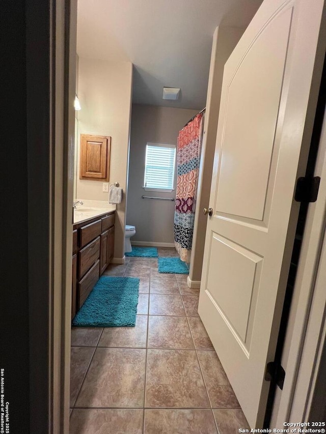 bathroom featuring vanity, toilet, and tile patterned floors