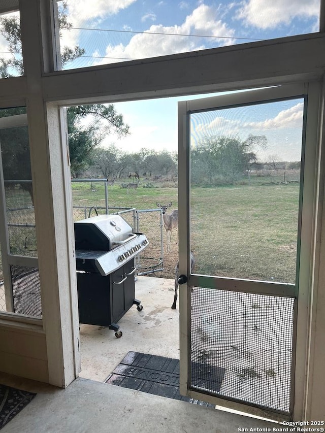 entryway with a rural view and concrete flooring