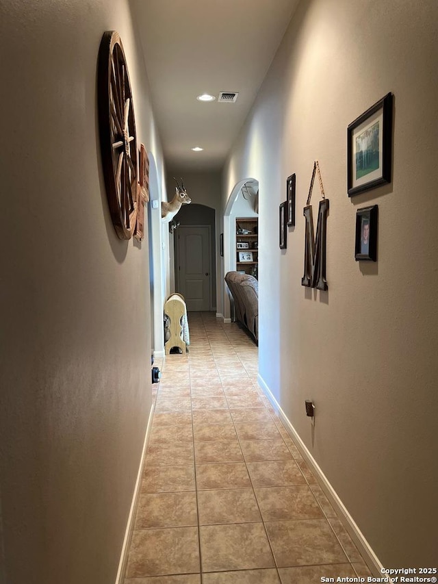 hallway featuring light tile patterned flooring