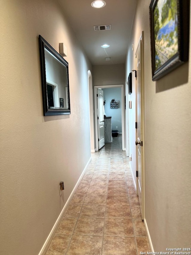 hall featuring light tile patterned flooring