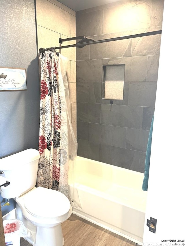 bathroom with toilet, wood-type flooring, and shower / bath combo