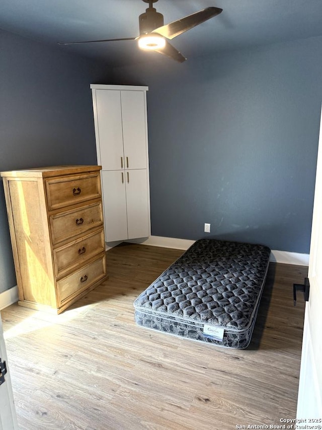 bedroom featuring ceiling fan and light hardwood / wood-style floors