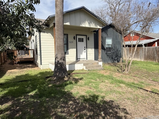 bungalow-style home with a front yard