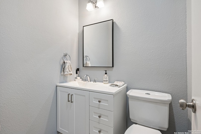 bathroom featuring toilet and vanity