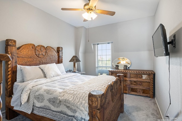 carpeted bedroom with vaulted ceiling and ceiling fan