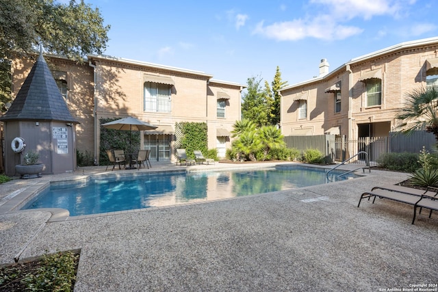 view of swimming pool with a patio area