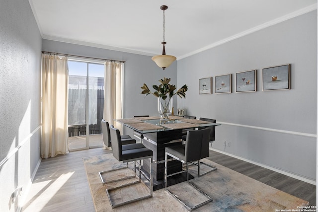 dining room featuring ornamental molding and hardwood / wood-style floors