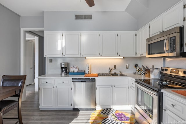 kitchen featuring white cabinetry, dark wood-type flooring, appliances with stainless steel finishes, and sink