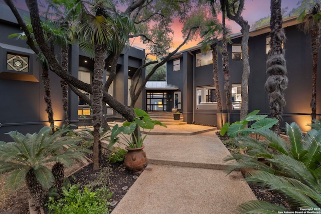 exterior space with metal roof and stucco siding