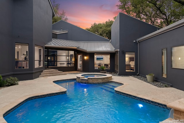 view of swimming pool with a pool with connected hot tub and a patio area