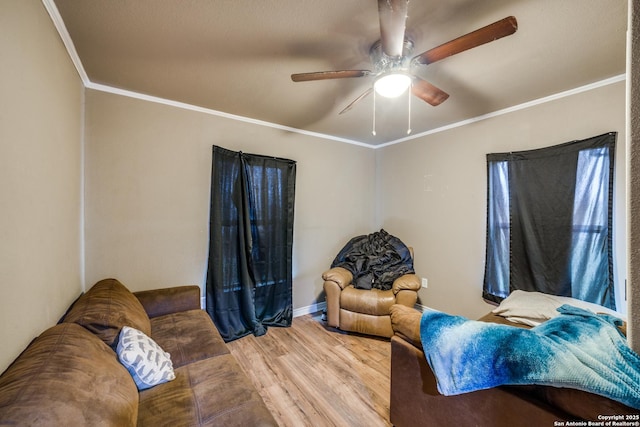 living room with ceiling fan, ornamental molding, and wood-type flooring