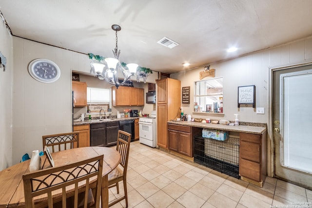 kitchen featuring an inviting chandelier, sink, light tile patterned floors, black appliances, and hanging light fixtures