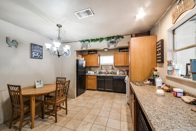 kitchen with hanging light fixtures, black appliances, sink, light tile patterned floors, and a chandelier