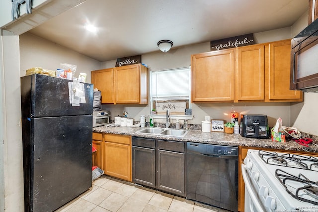 kitchen featuring light tile patterned floors, sink, and black appliances