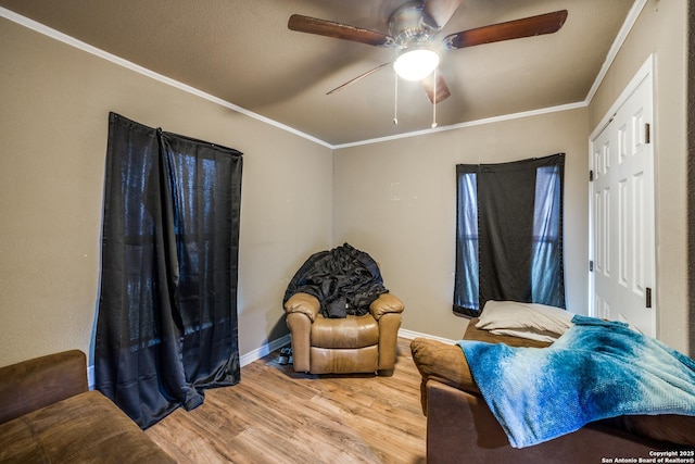 living room with hardwood / wood-style floors, crown molding, and ceiling fan