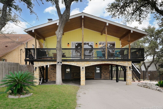 back of property featuring a deck and a carport