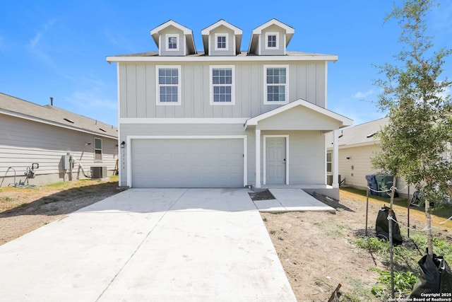 view of front of property featuring central AC unit and a garage