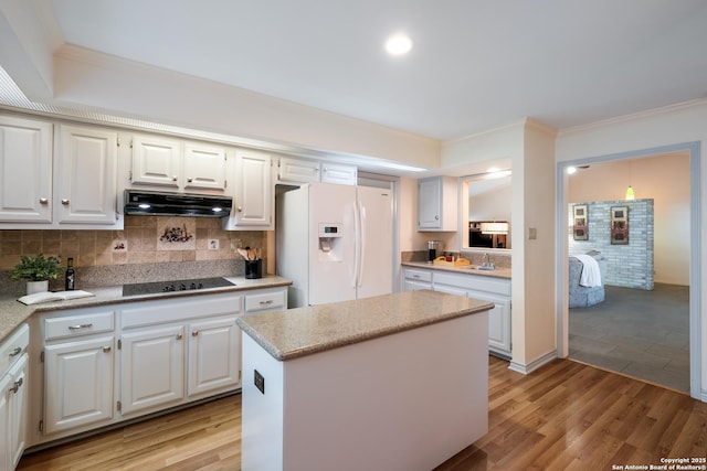 kitchen with white fridge with ice dispenser, light wood-style flooring, under cabinet range hood, and black electric stovetop