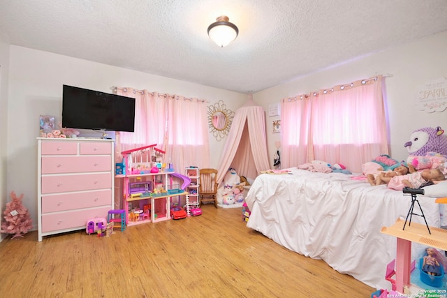 bedroom featuring a textured ceiling and hardwood / wood-style floors