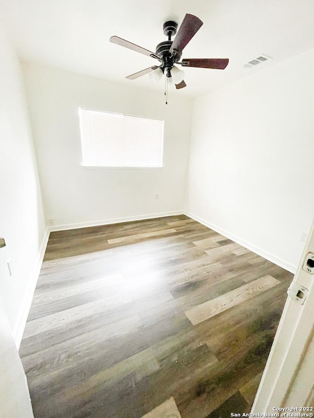 unfurnished room with ceiling fan and wood-type flooring