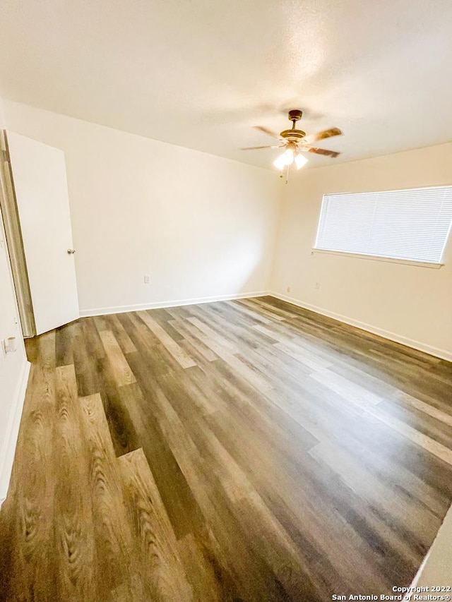 empty room with ceiling fan and wood-type flooring