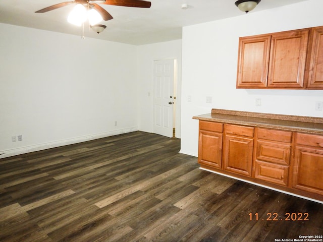 kitchen featuring ceiling fan and dark hardwood / wood-style flooring