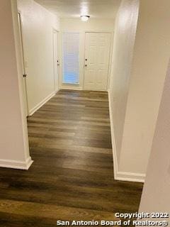 hall with dark hardwood / wood-style flooring