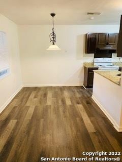 unfurnished dining area featuring dark wood-type flooring