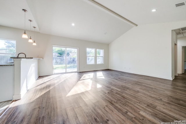 5023 Stockman Dr, San Antonio, TX 78247 - unfurnished living room featuring visible vents, recessed lighting, wood finished floors, vaulted ceiling with beams, and baseboards