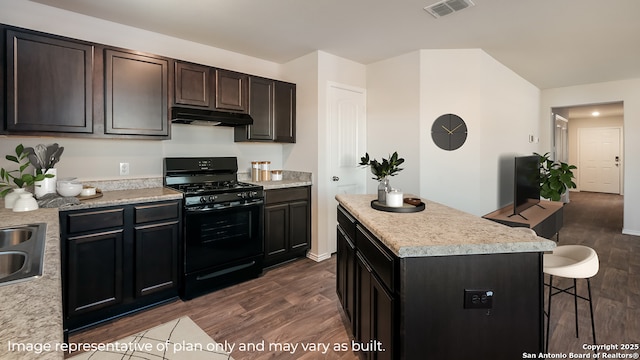 kitchen featuring sink, a kitchen island, dark hardwood / wood-style flooring, and black gas range