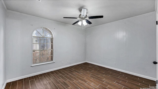 spare room featuring ornamental molding, ceiling fan, and dark wood-type flooring