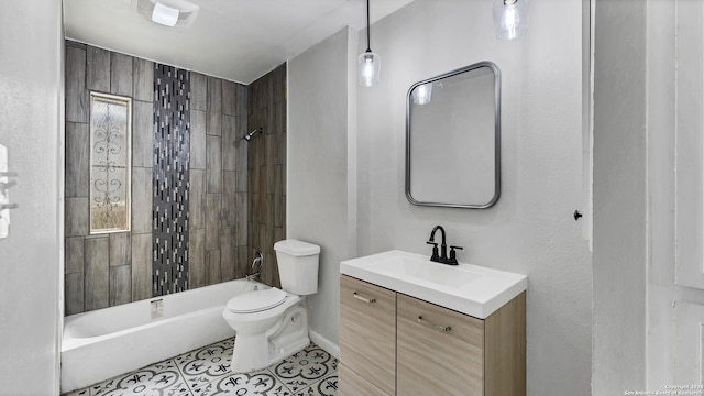 full bathroom featuring tile patterned floors, vanity, toilet, and tiled shower / bath