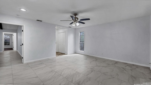 spare room featuring ceiling fan