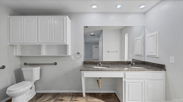 bathroom with toilet and vanity